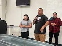 a group of people standing in front of a tub