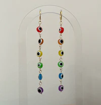 a pair of colorful evil eye dangling earrings