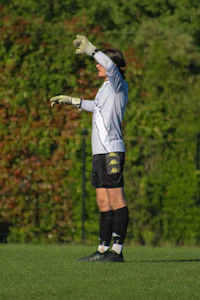 a woman is playing soccer on a field