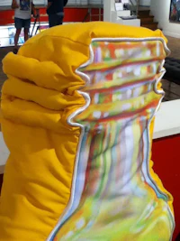 a yellow chair with a bottle on it