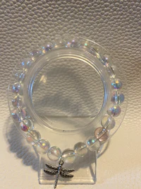 a clear glass holder with a dragonfly on it