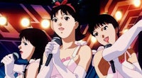 three anime girls holding microphones in front of a stage