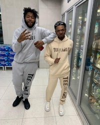 two men standing next to each other in a store