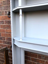 a white fireplace with a white shelf on it