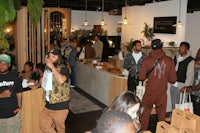 a group of people standing in a restaurant