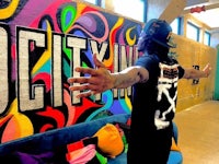 a man standing in front of a colorful wall
