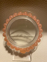 a mirror with pink beads on it