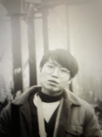 an old photo of a man with glasses