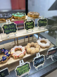 a display of donuts in a glass case