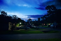 a car parked on a street at dusk