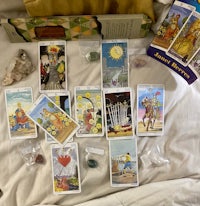 tarot cards and other items on a bed
