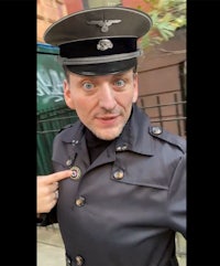 a man in a military uniform pointing his finger