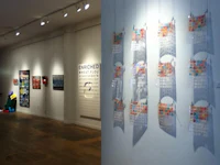 an art gallery with a lot of art hanging on the wall