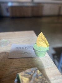 guacamole in a cup on a wooden table