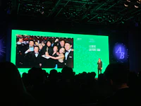 a group of people standing in front of a green screen