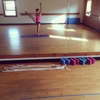 a woman doing a yoga pose in a room