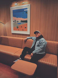 a man sitting on a brown couch