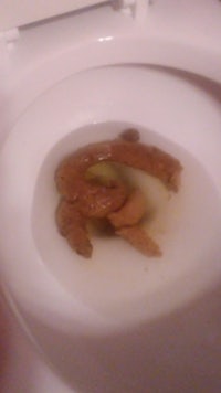 a toilet with a piece of food in it