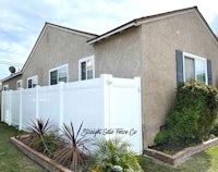a house with a white fence in front of it