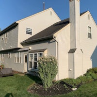 a home with white siding and a lawn