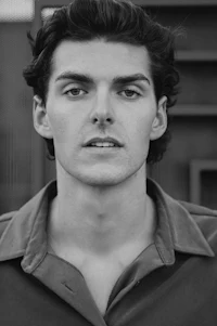 a black and white photo of a young man
