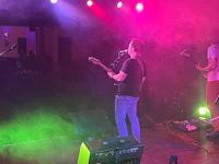 a group of people on stage at a concert