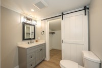 a bathroom with a sliding barn door