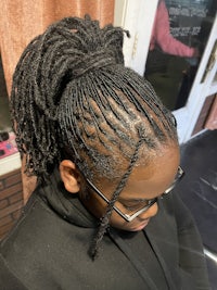a woman with dreadlocks in a salon