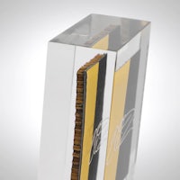 a clear glass trophy with a yellow and black design