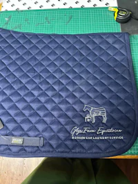 a blue saddle pad with a logo on it