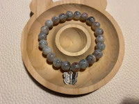 a bracelet with a teddy bear charm on it