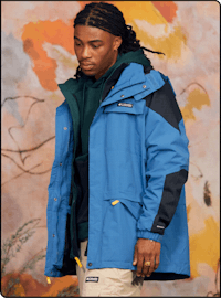 a young man in a blue jacket with dreadlocks