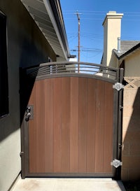 a brown wooden gate in front of a house