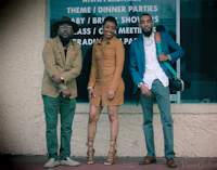 three people standing in front of a building