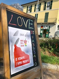 a sign in front of a building that says love
