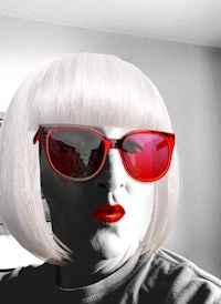 a woman with a white wig and red sunglasses