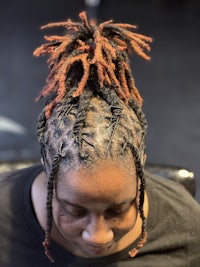 a woman with dreadlocks in her hair