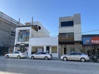 two cars are parked in front of a building