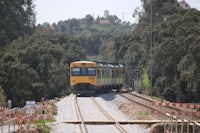 a yellow train traveling down a train track