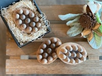 two soaps in a box on top of a wooden table