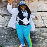 a woman posing for a photo in a colorful outfit