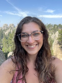 a woman wearing glasses and a striped shirt