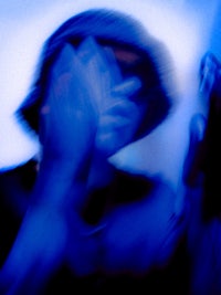 a blurry image of a person holding a cell phone