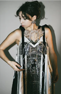 a woman wearing a black and white dress