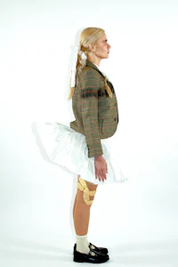 a woman wearing a skirt and jacket