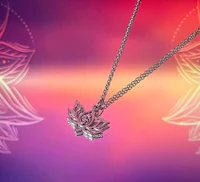 a silver necklace with a lotus flower on it