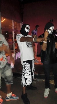 a group of people with masks standing next to each other