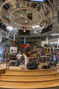 a group of people playing music in a shopping mall