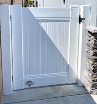 a white gate in front of a house
