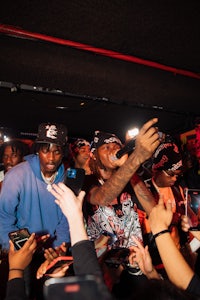 a group of people posing for a picture in front of a crowd